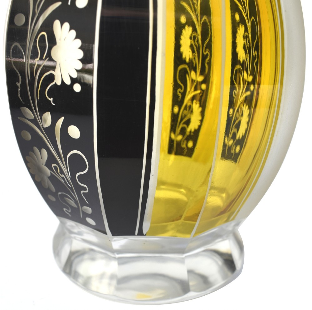 A faceted clear glass Art Deco perfume bottle with yellow and black geometric stained panels, floral etching, and a matching faceted geometric stopper. View IV