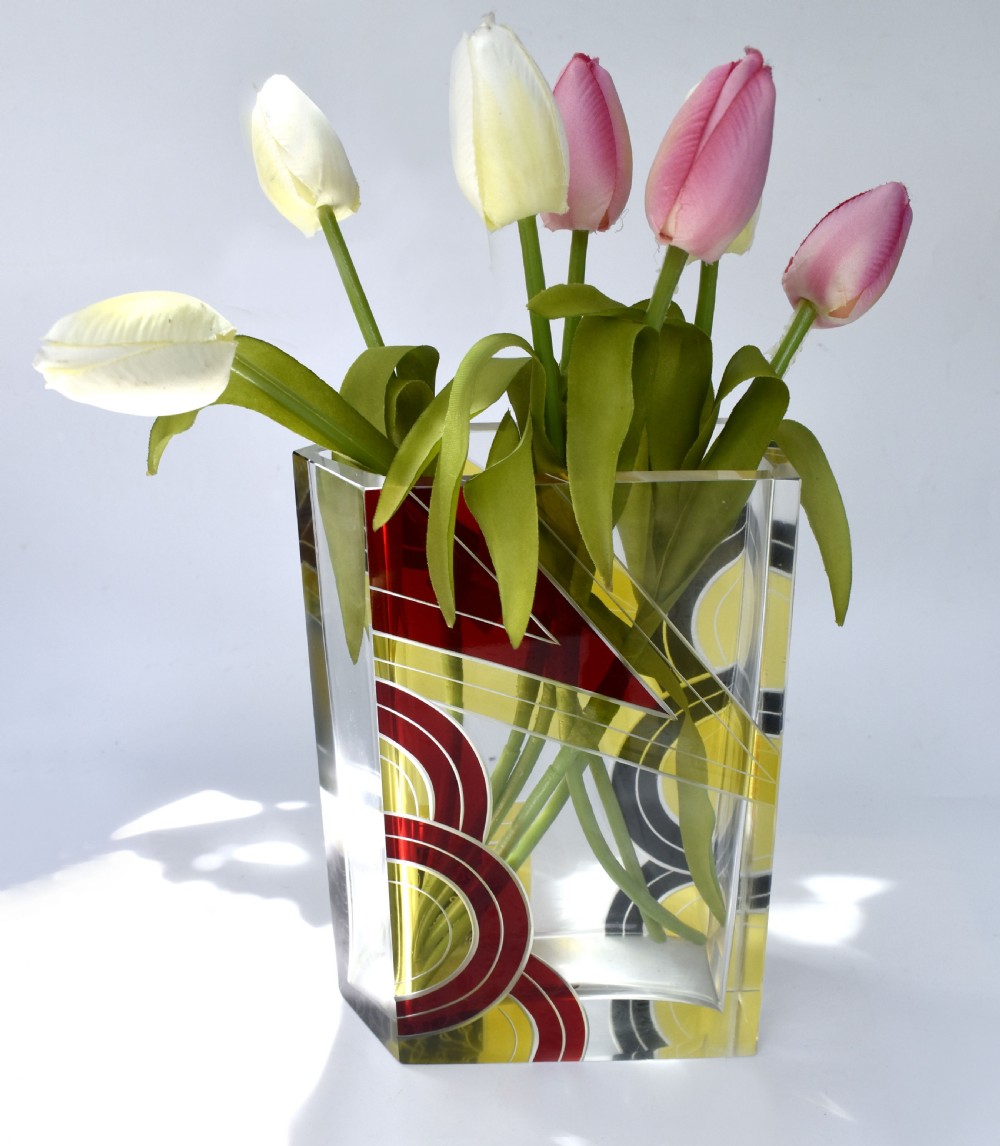 A rectangular clear glass Art Deco vase decorated with etched patterns and enamelled geometric shapes in black, yellow, and red. View IV