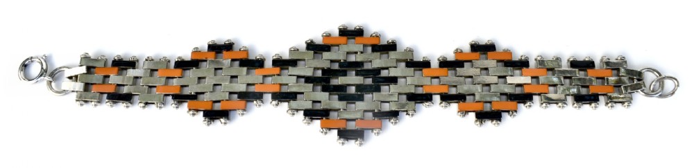 An Art Deco bracelet constructed with silver-tone chrome, black, and orange rectangular links arranged in a staggered brickwork motif. View II