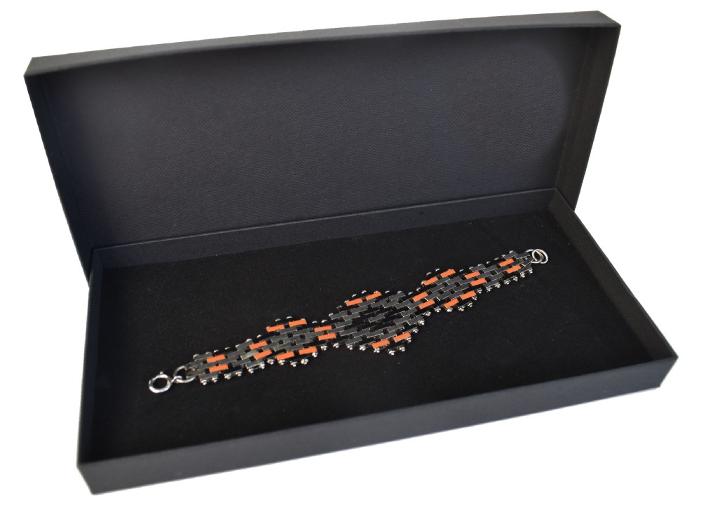 An Art Deco bracelet constructed with silver-tone chrome, black, and orange rectangular links arranged in a staggered brickwork motif. View IV