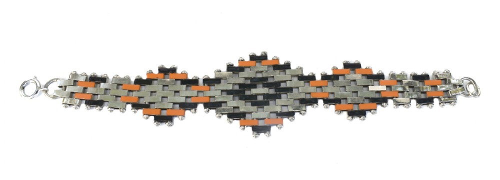 An Art Deco bracelet constructed with silver-tone chrome, black, and orange rectangular links arranged in a staggered brickwork motif. View V