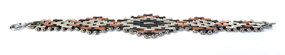An Art Deco bracelet constructed with silver-tone chrome, black, and orange rectangular links arranged in a staggered brickwork motif. View VI