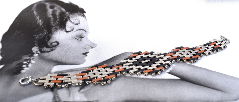 An Art Deco bracelet constructed with silver-tone chrome, black, and orange rectangular links arranged in a staggered brickwork motif. View VIII