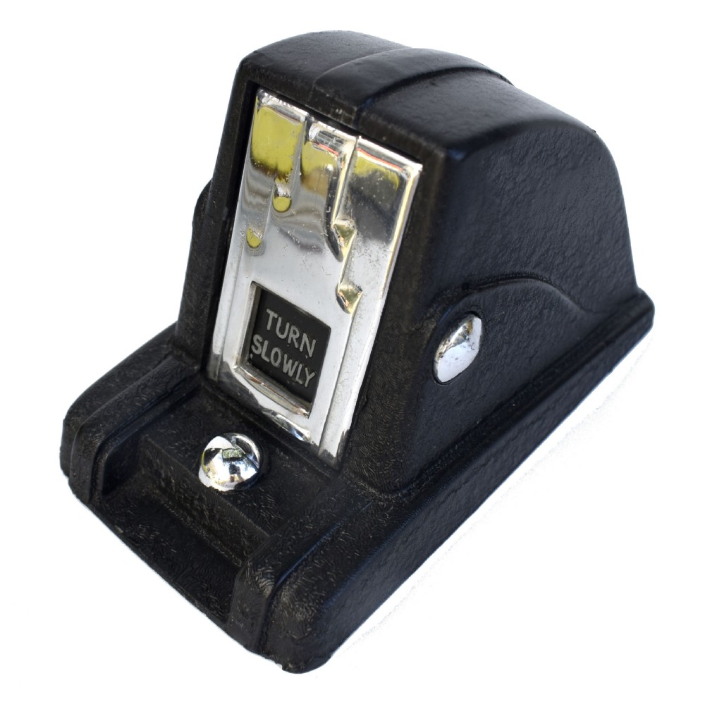 A black textured Bakelite and chrome Art Deco perpetual desk calendar featuring a geometric stepped frame with the text BRITISH MADE displayed. View III