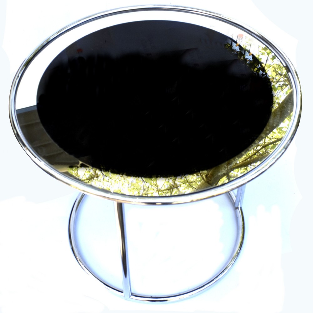 A circular Art Deco occasional table featuring a reflective chrome tubular metal frame and a black and clear glass top. View II