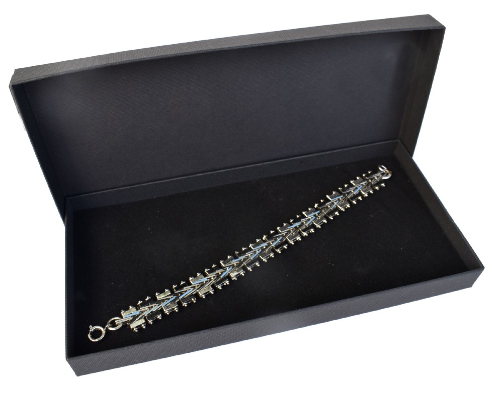 An Art Deco chrome-plated link bracelet featuring geometric black and light blue enamel accents in a machine-age pattern. View IV