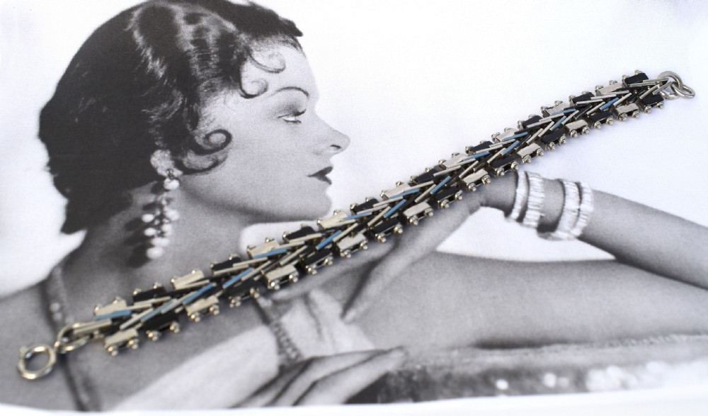 An Art Deco chrome-plated link bracelet featuring geometric black and light blue enamel accents in a machine-age pattern. View V