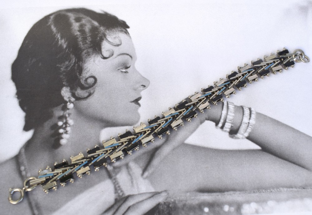 An Art Deco chrome-plated link bracelet featuring geometric black and light blue enamel accents in a machine-age pattern. View VI
