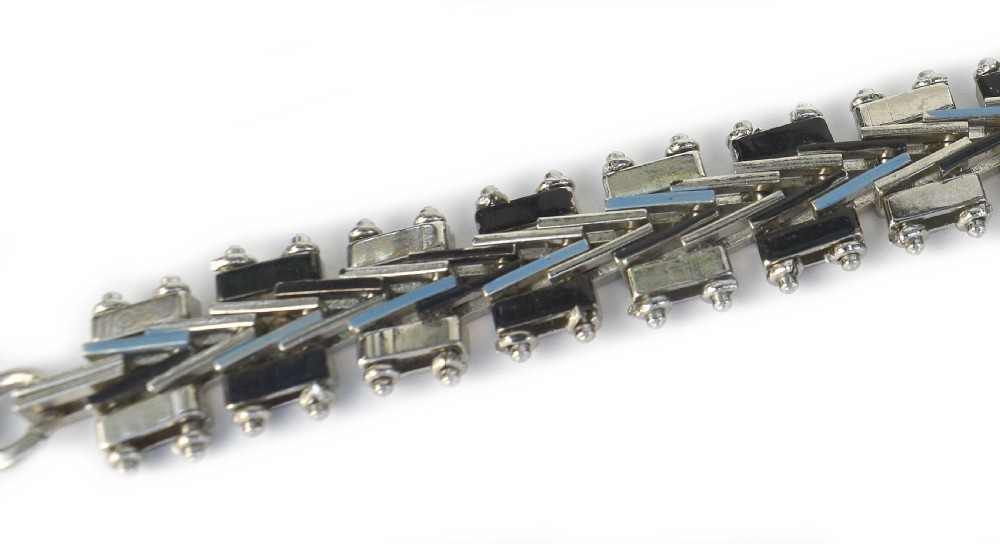 An Art Deco chrome-plated link bracelet featuring geometric black and light blue enamel accents in a machine-age pattern. View VIII
