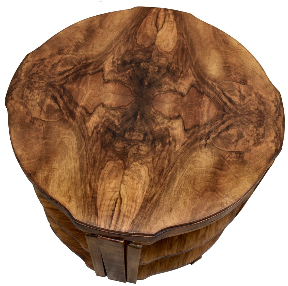 An Art Deco circular walnut coffee table housing four matching triangular side tables beneath its top. View II