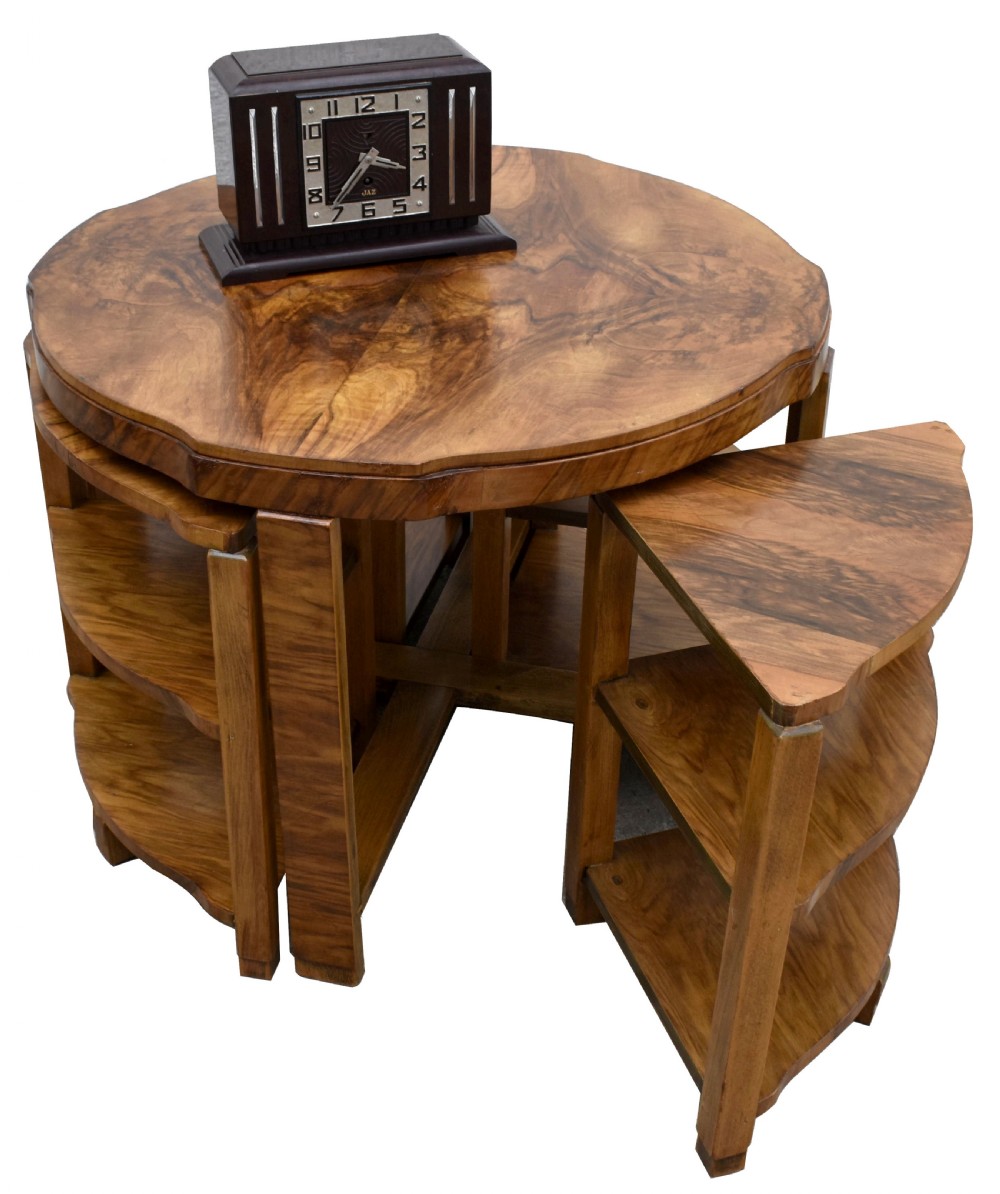 An Art Deco circular walnut coffee table housing four matching triangular side tables beneath its top. View IV