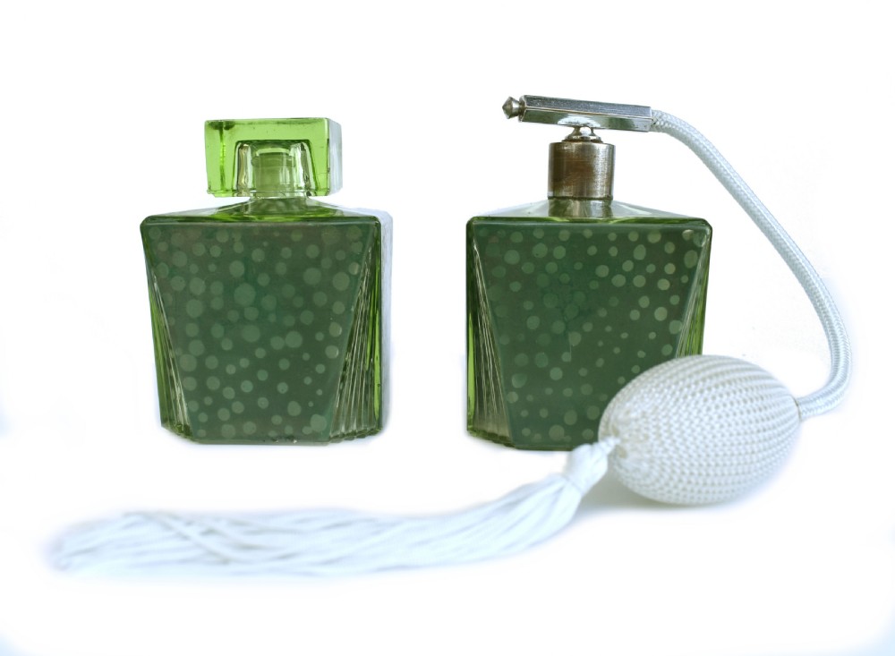 A pair of green Art Deco glass perfume bottles featuring a polka dot pattern, one with a glass stopper and the other with a chrome atomiser pump. View II