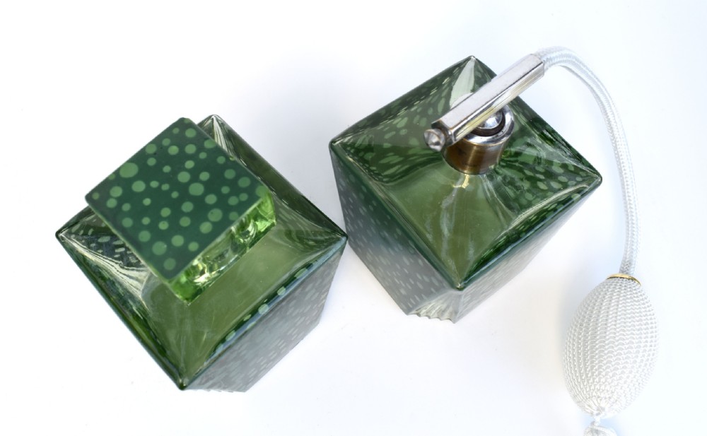 A pair of green Art Deco glass perfume bottles featuring a polka dot pattern, one with a glass stopper and the other with a chrome atomiser pump. View III