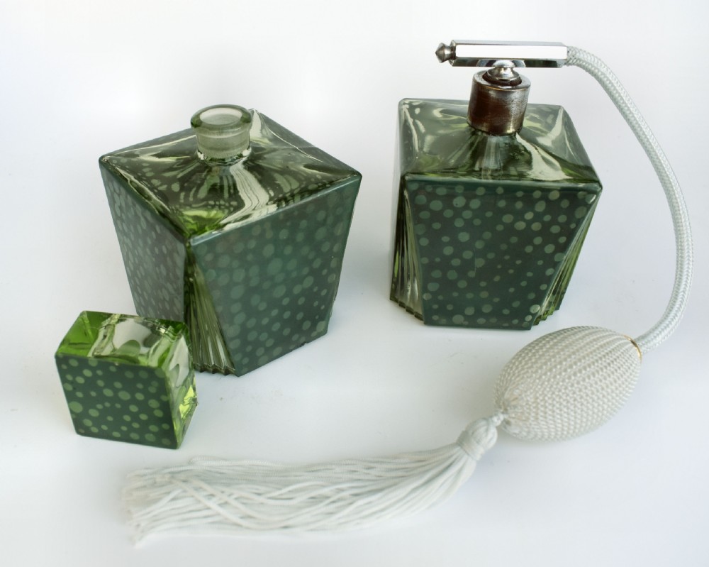 A pair of green Art Deco glass perfume bottles featuring a polka dot pattern, one with a glass stopper and the other with a chrome atomiser pump. View V