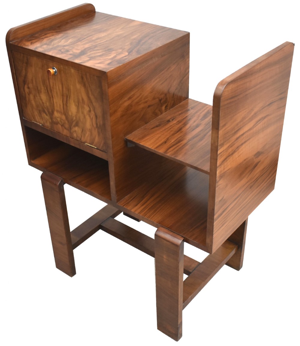 An Art Deco walnut telephone table featuring asymmetrical shelving, a small drop-down cabinet with figured grain, and straight slab legs, circa 1930. View III