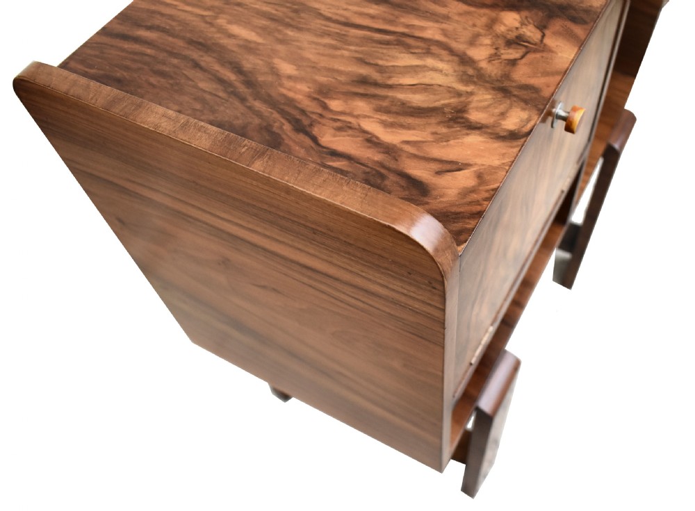 An Art Deco walnut telephone table featuring asymmetrical shelving, a small drop-down cabinet with figured grain, and straight slab legs, circa 1930. View V