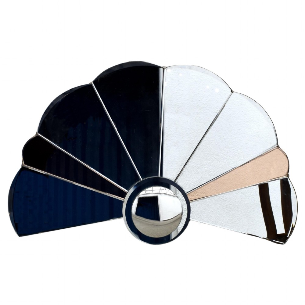 An Art Deco fan-shaped frameless wall mirror featuring segmented silvered textured glass panels and peach-tinted glass accents radiating from a central disc. View V