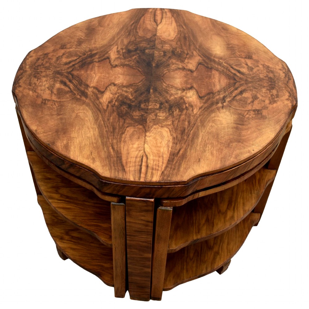 An Art Deco circular walnut coffee table housing four matching triangular side tables beneath its top. View IX