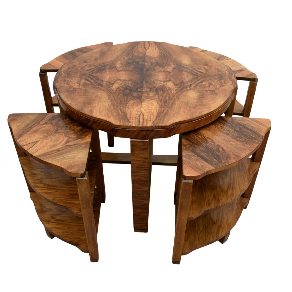 An Art Deco circular walnut coffee table housing four matching triangular side tables beneath its top. View X