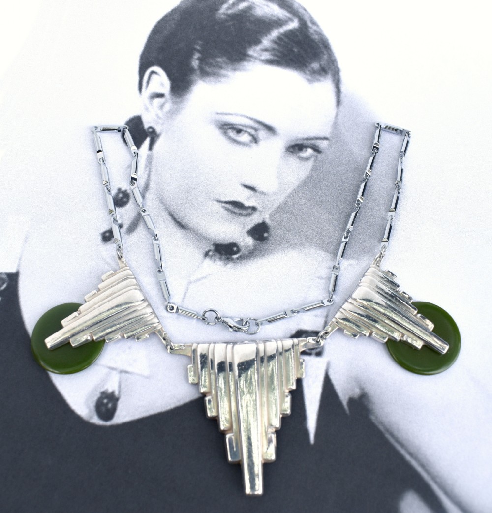 An Art Deco chrome link necklace featuring three stepped geometric metal pendants accented with circular green Bakelite discs. View III