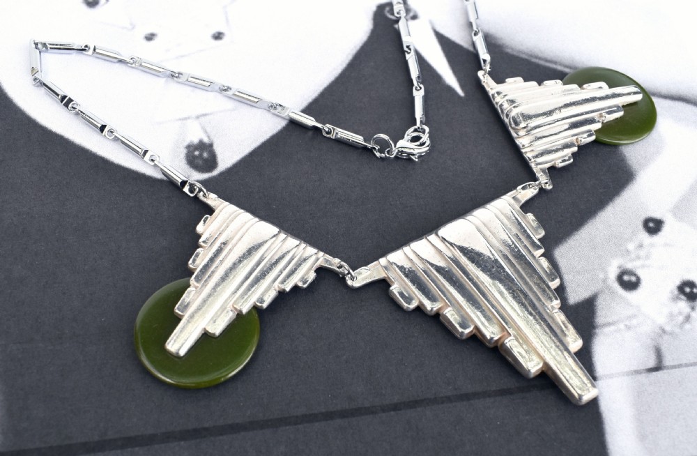 An Art Deco chrome link necklace featuring three stepped geometric metal pendants accented with circular green Bakelite discs. View IV