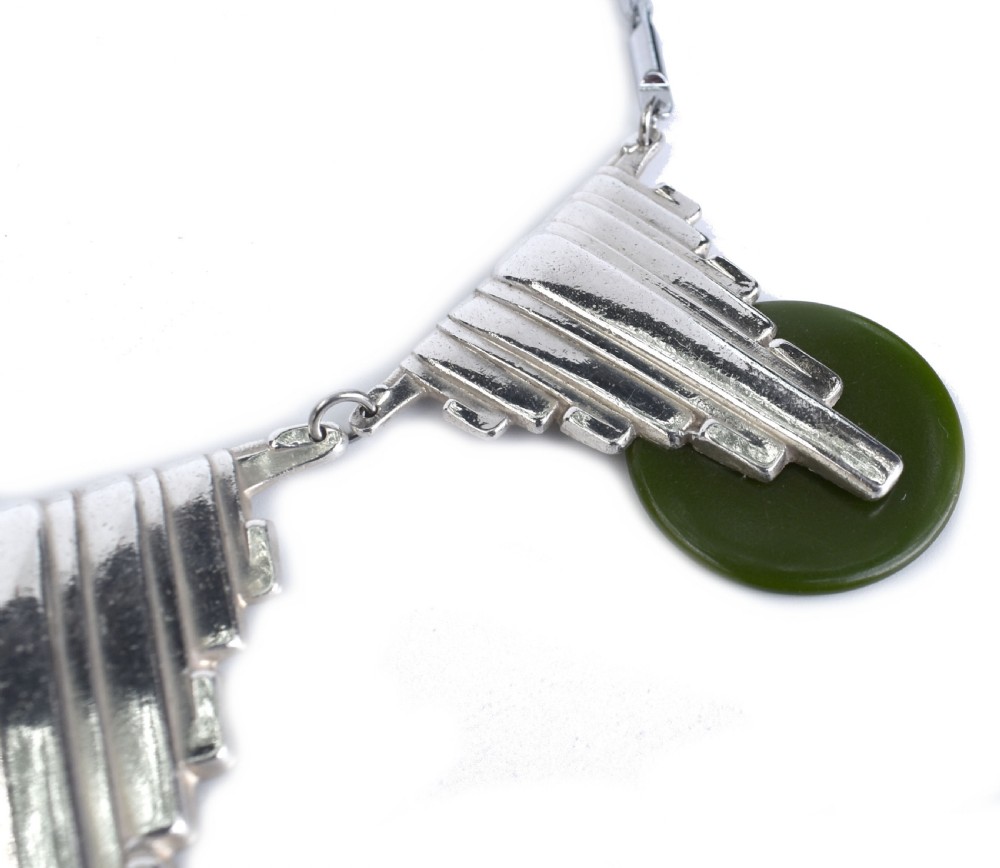 An Art Deco chrome link necklace featuring three stepped geometric metal pendants accented with circular green Bakelite discs. View VI