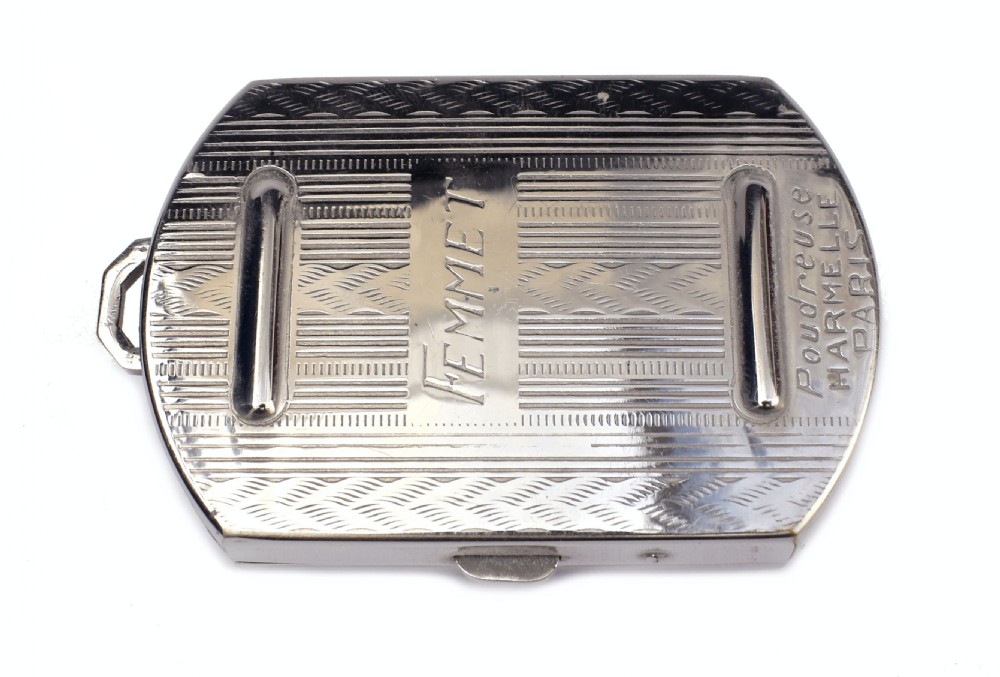 An Art Deco rectangular chrome powder compact decorated with black, green, and white geometric enamel inlay. View III