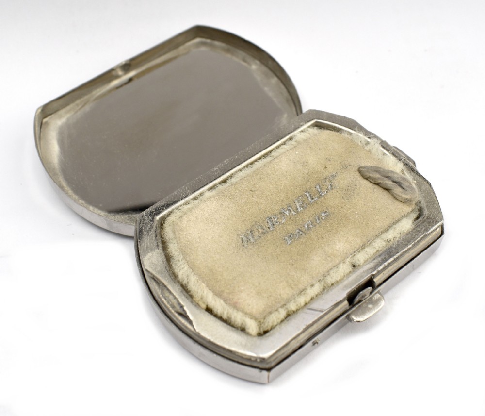 An Art Deco rectangular chrome powder compact decorated with black, green, and white geometric enamel inlay. View V
