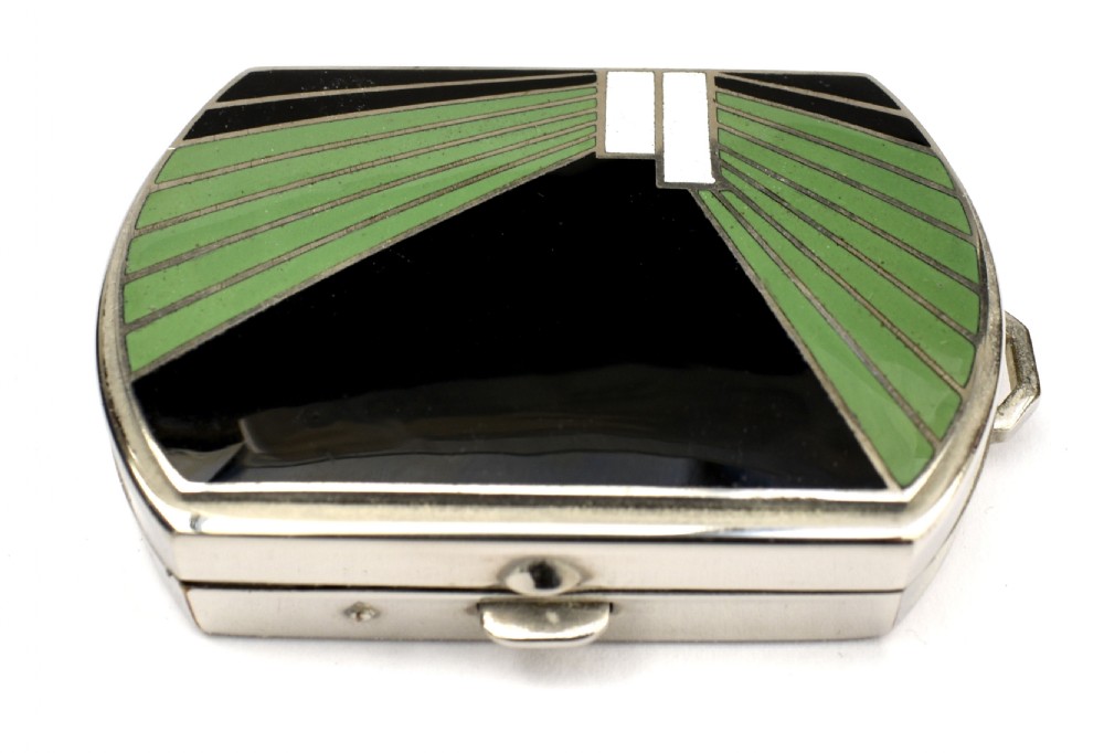 An Art Deco rectangular chrome powder compact decorated with black, green, and white geometric enamel inlay. View IX