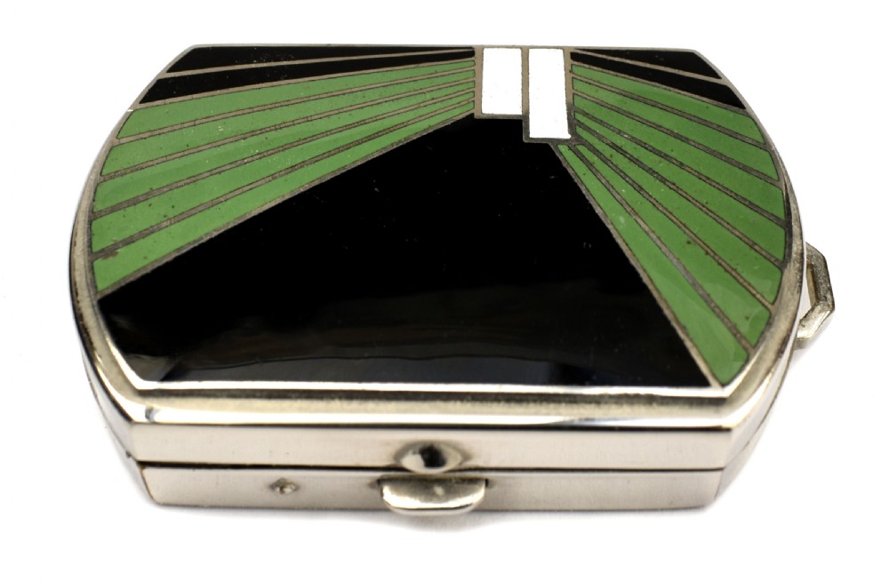 An Art Deco rectangular chrome powder compact decorated with black, green, and white geometric enamel inlay. View X