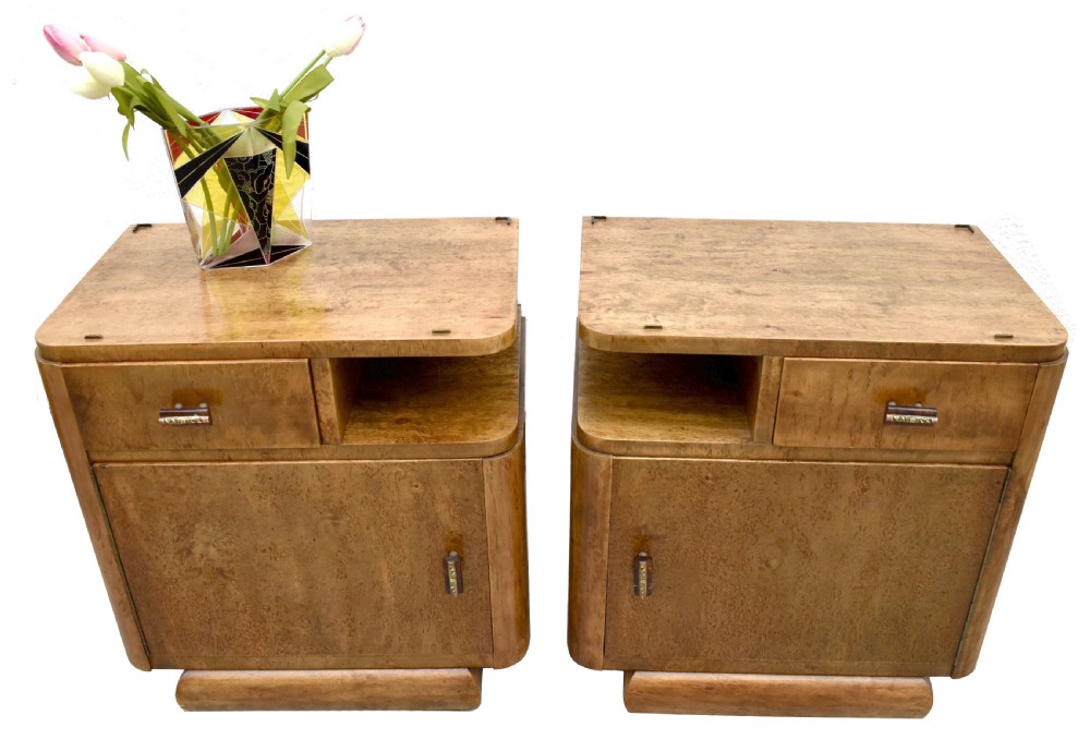 A matching pair of 1930s Art Deco burr elm bedside cabinets featuring top drawers, open compartments, single-door cupboards, and rounded plinth bases. View IX