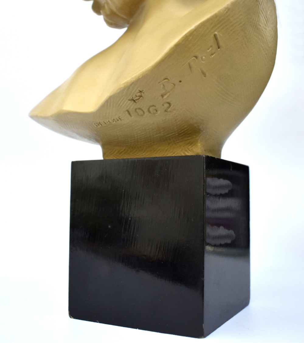 A terracotta Art Deco female bust depicting a woman with swept-back wavy hair looking upwards, mounted on a square black wooden plinth. View VIII
