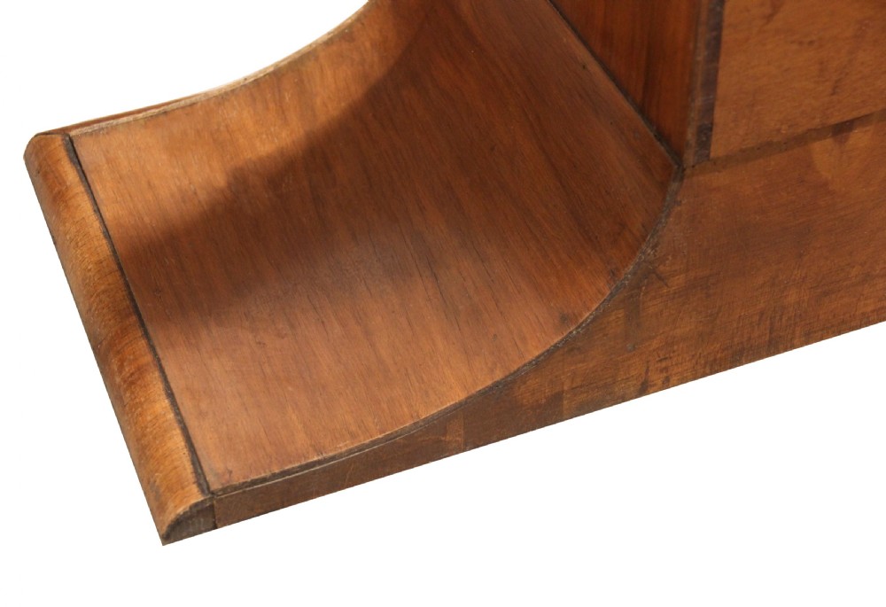 An octagonal Art Deco display cabinet made of warm brown walnut with two glazed doors and interior glass shelves on a plinth base. View VI