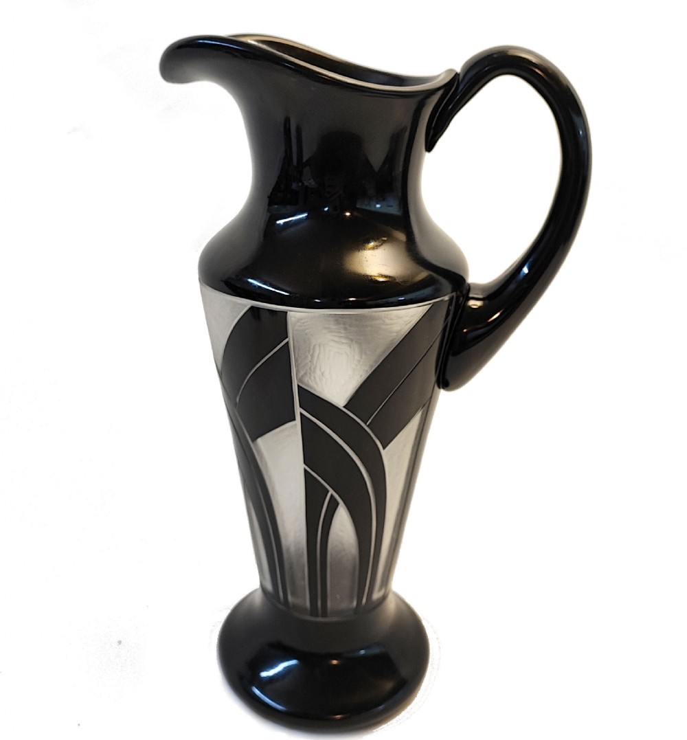 An Art Deco black and frosted glass drinks set featuring a tall jug and six matching tumblers decorated with geometric black arch patterns. View III
