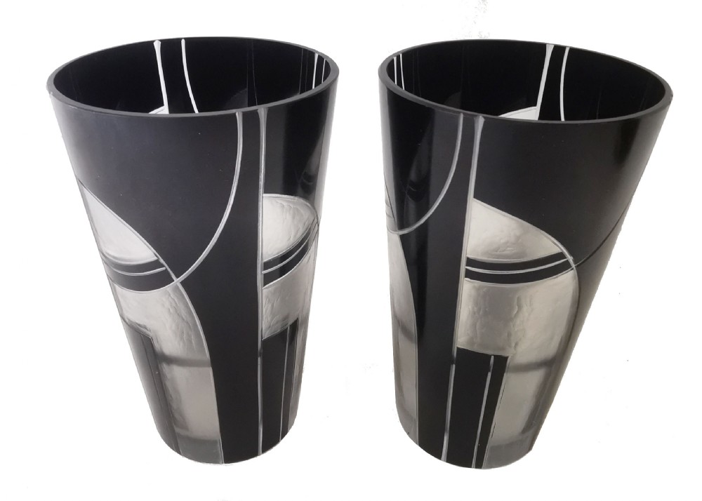 An Art Deco black and frosted glass drinks set featuring a tall jug and six matching tumblers decorated with geometric black arch patterns. View VI