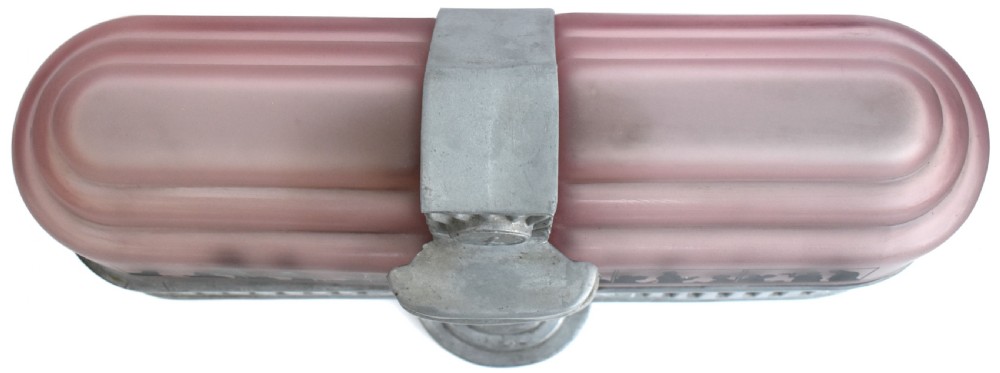An Art Deco style lamp featuring a stepped pink frosted glass body decorated with black silhouetted figures dining inside windows, framed by a silver-coloured cast metal base and central architectural doorway with a clock motif. View VII