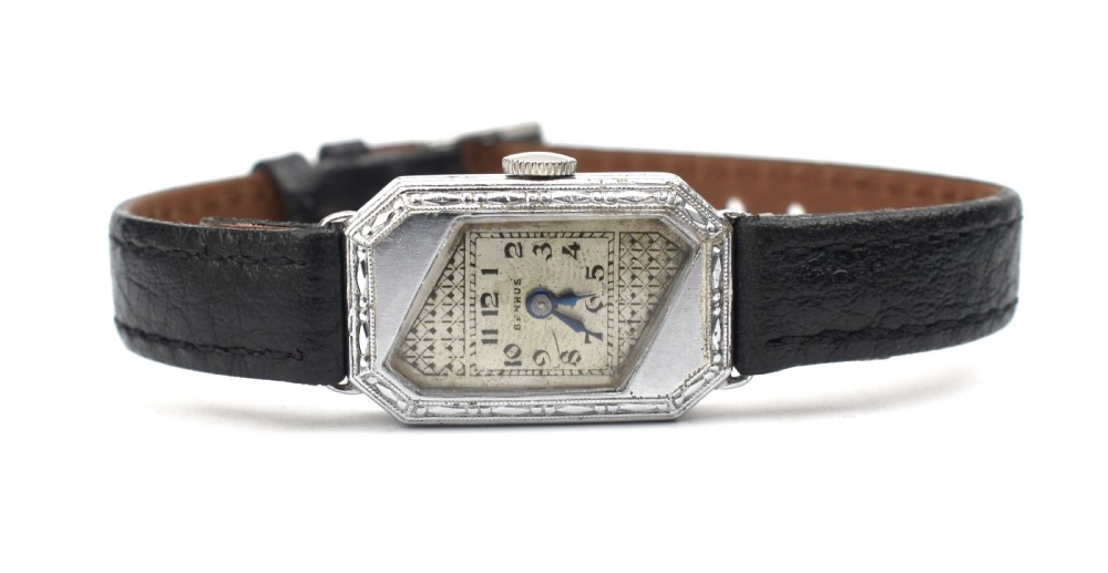 An Art Deco ladies wristwatch featuring an octagonal engraved 14k white gold case, a patterned geometric dial, blue hands, and a black leather strap. View III