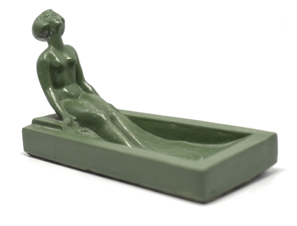 A green Art Deco spelter pin dish featuring a reclining female figure resting along the edge of a small rectangular tray. View II