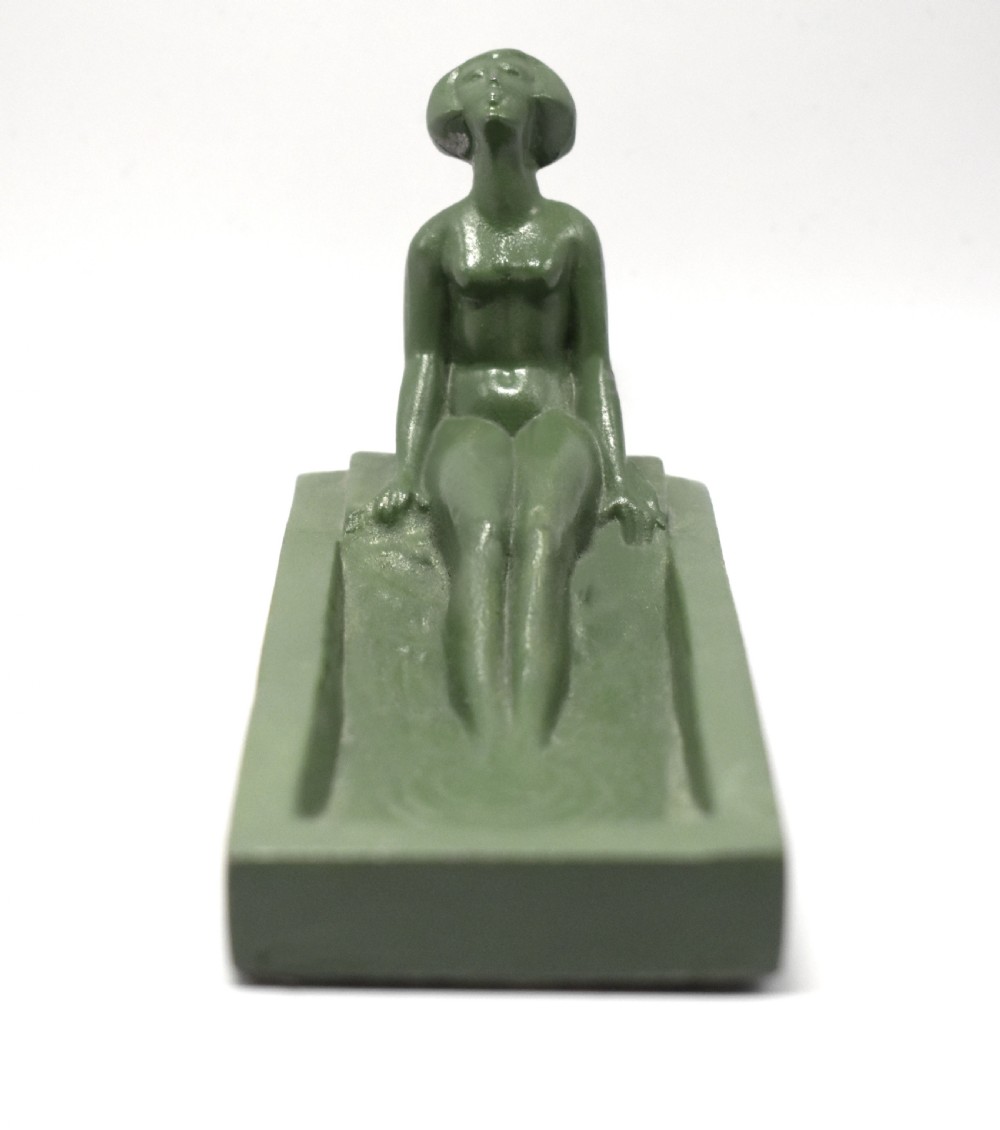 A green Art Deco spelter pin dish featuring a reclining female figure resting along the edge of a small rectangular tray. View V