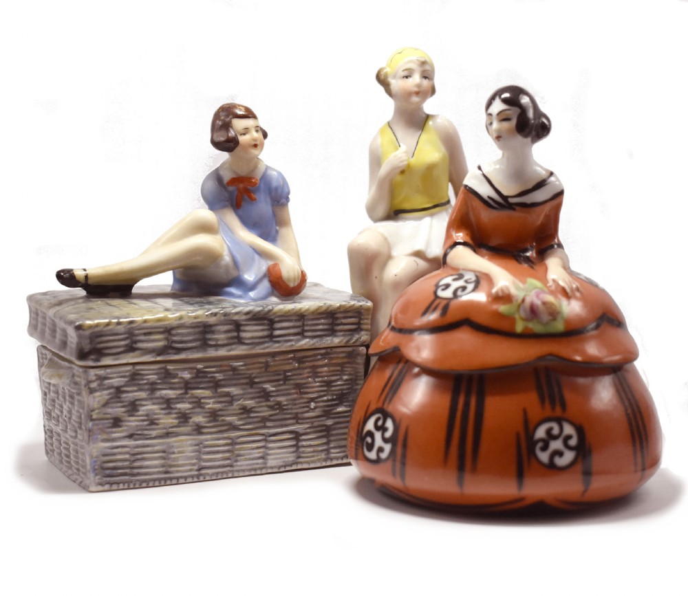 An Art Deco glazed ceramic powder bowl featuring a lid shaped as a lady in a terracotta and black dress holding a flower. View VIII