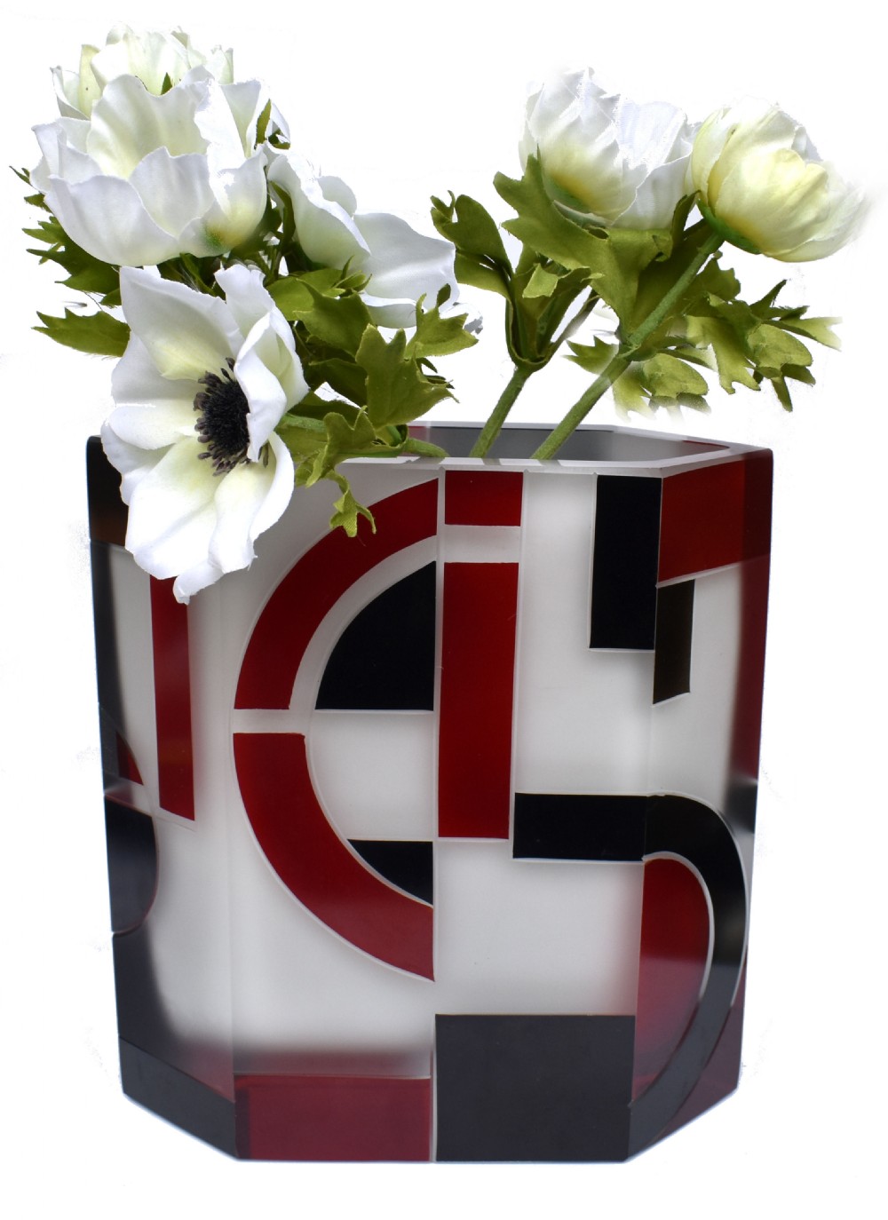 An Art Deco hexagonal opaque glass vase featuring bold red and black geometric enamel motifs.