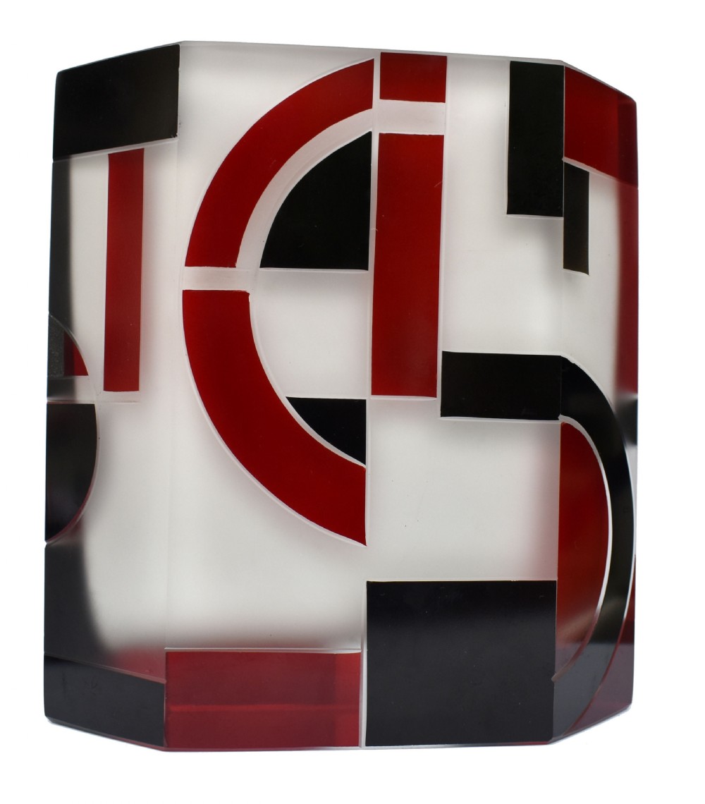 An Art Deco hexagonal opaque glass vase featuring bold red and black geometric enamel motifs. View II