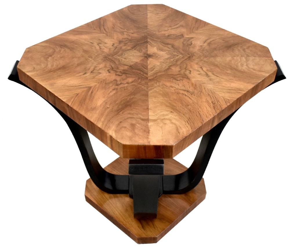 An Art Deco occasional table featuring an octagonal walnut veneer top supported by four curved ebonised legs resting on an octagonal base. View II