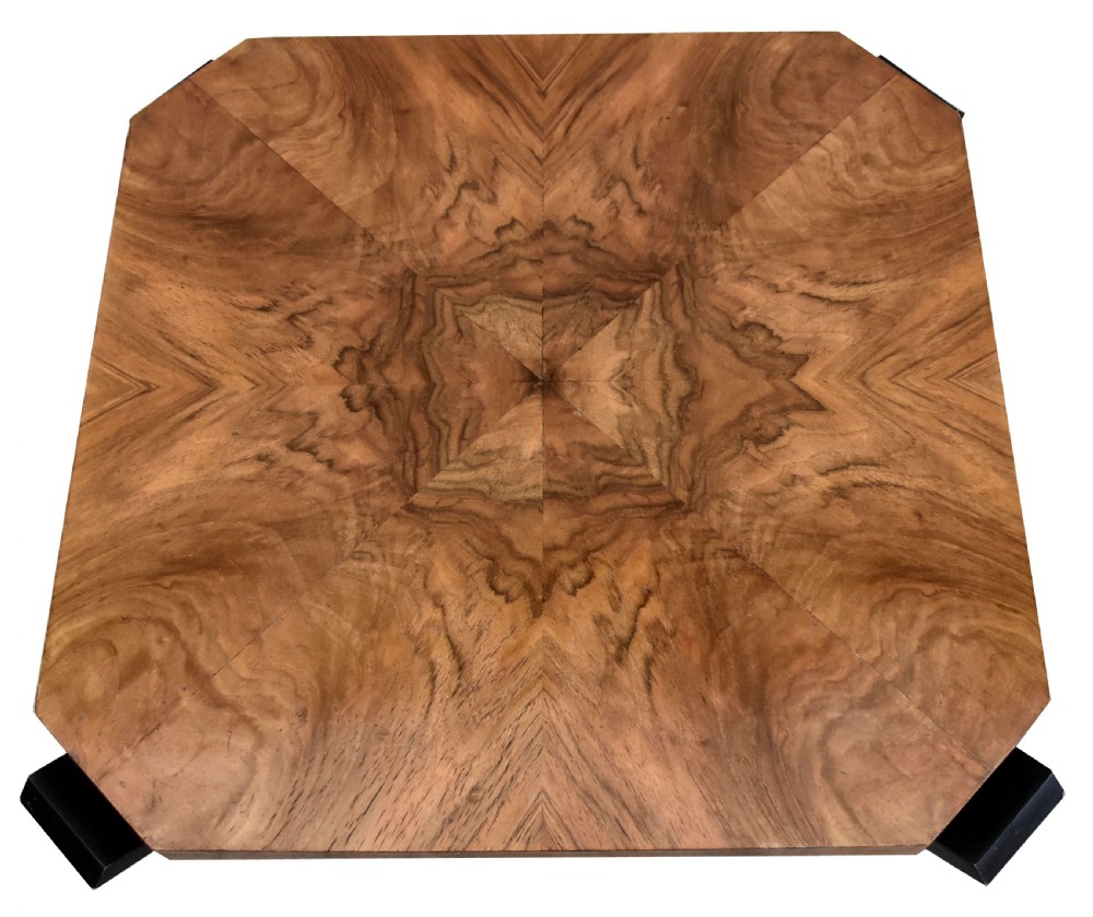 An Art Deco occasional table featuring an octagonal walnut veneer top supported by four curved ebonised legs resting on an octagonal base. View IV