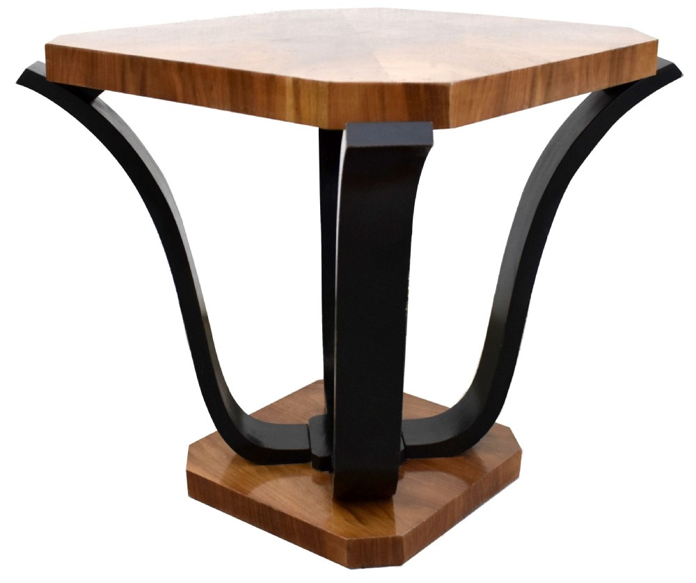 An Art Deco occasional table featuring an octagonal walnut veneer top supported by four curved ebonised legs resting on an octagonal base. View V