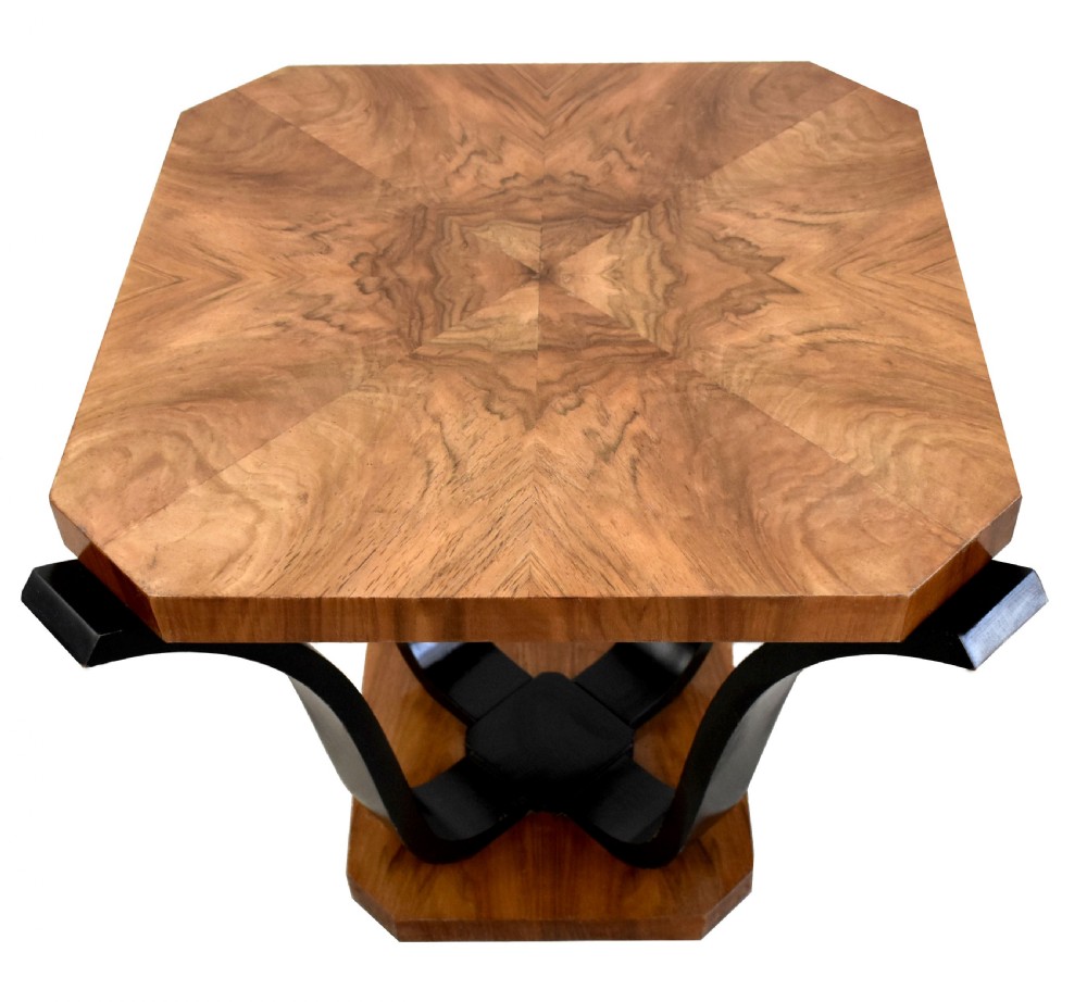 An Art Deco occasional table featuring an octagonal walnut veneer top supported by four curved ebonised legs resting on an octagonal base. View VI