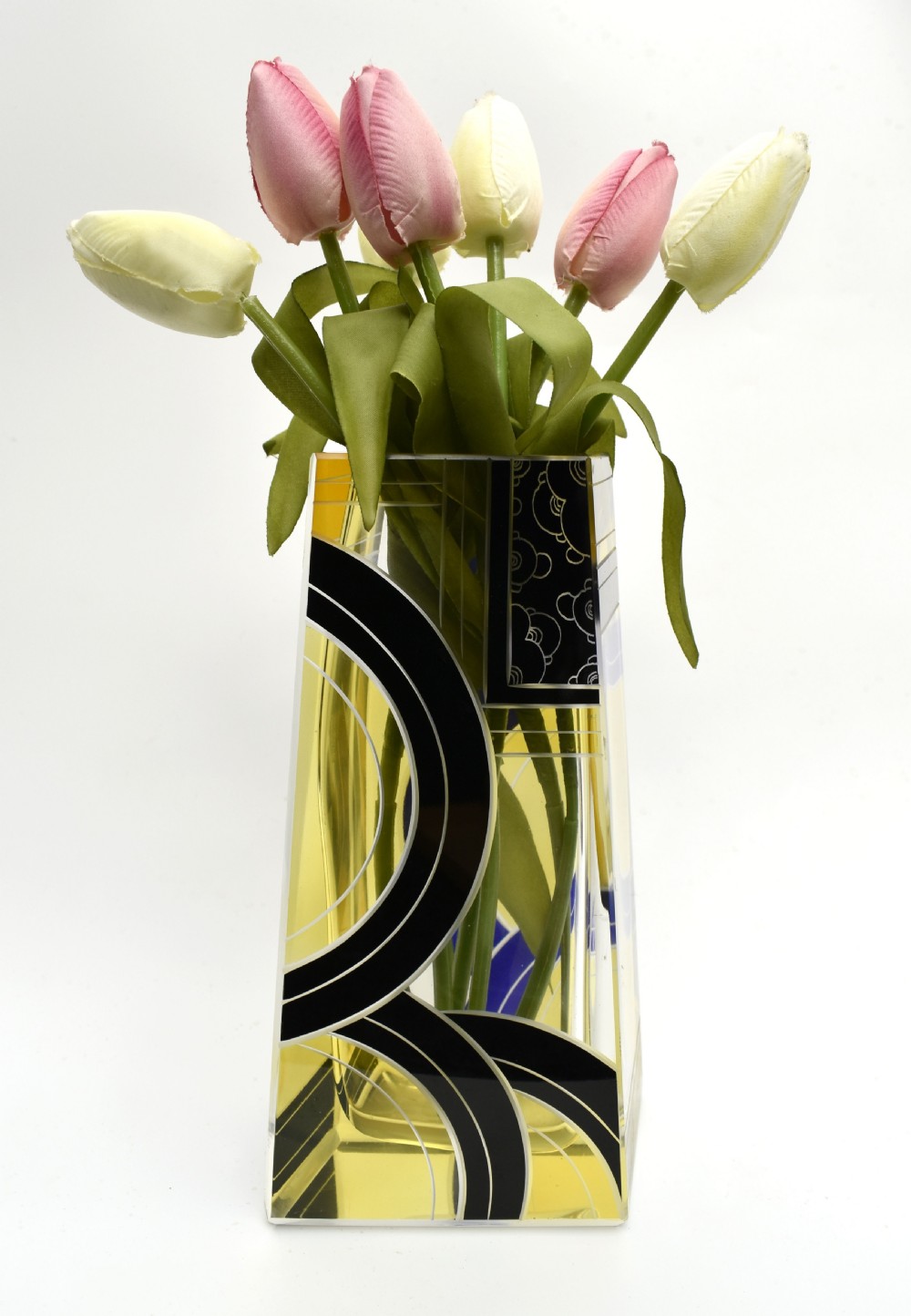 A tall tapered rectangular clear glass vase decorated with black enamel arcs, yellow panels, and etched geometric patterns.