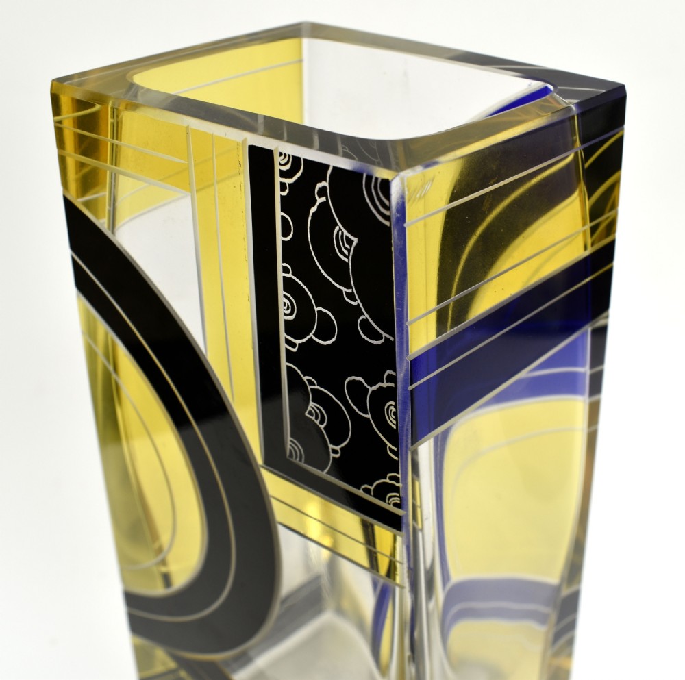 A tall tapered rectangular clear glass vase decorated with black enamel arcs, yellow panels, and etched geometric patterns. View XI