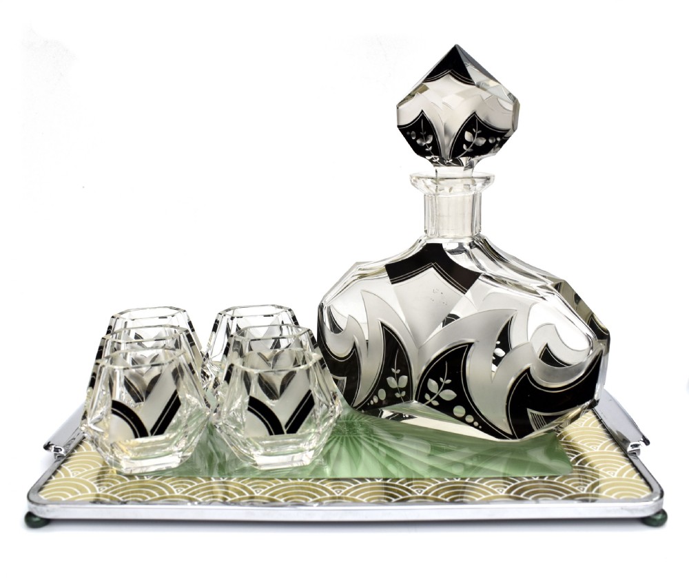 An Art Deco clear glass decanter set featuring black enamelled geometric patterns and frosted accents, accompanied by six matching faceted glasses and a faceted stopper. View III
