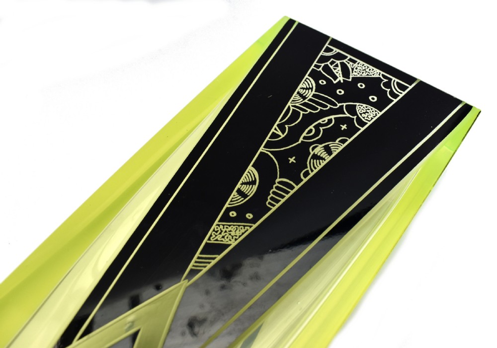 A tall rectangular yellow-green glass vase featuring black geometric Art Deco enamel patterns. View II